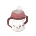 Przezroczysty kubek niekapek Canpol babies FirstCup 150ml w kolorze różowym z silikonowym ustnikiem i dwoma uchwytami, ozdobiony wizerunkami zwierzątek.