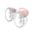 Podwójny laktator muszlowy Babyono TWINNY 1002 w kolorze różowym i przezroczystym, ukazany z obu stron, połączony przewodem