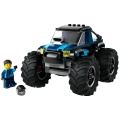 Niebieski monster truck LEGO City 60402 z ogromnymi oponami obok minifigurki kierowcy i kasku.